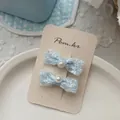 Détail de barrettes noeuds en dentelle bleue avec perles sur carte support - Barrette à Cheveux Nœud Perle Artificielle