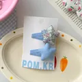 Detail of floral and blue star fabric hair clips on brand display card for girls - Blue Star Hair Clip