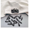 Detailed view of black teardrop BB hair clips set with a transparent plastic storage box - Black