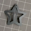 Matte dark grey star shaped snap hair clip for kids on a textured grey background - Gray