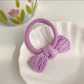 Charming purple bow hair tie with ribbed texture and high elastic band on shell dish - Light Purple