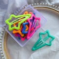 Star-shaped colorful glow-in-the-dark hair clips set in a transparent storage box - Shooting Star Style