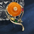 Exquisite golden brooch with round amber-like stone and colorful zircon accents - Prosperous Honey Wax