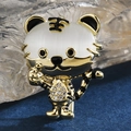 Macro shot of tiger brooch with opal head and gold-plated finish on dark blue background - Pipi Tiger