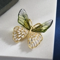 Elegant crystal butterfly brooch with green wings and golden zirconia accents for coats - Green