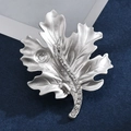 Silver matte maple leaf brooch with sparkling crystals on dark blue background - Leaf Beaded Style