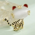 Cartoon tiger brooch featuring a white cat eye stone and red enamel ears in gold - Red Ear Little Tiger