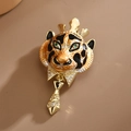 Golden tiger brooch with black enamel tiger stripes and green emerald gemstone eyes - Lion Face Tiger
