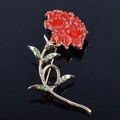 Elegant red carnation brooch with rhinestones and gold stem on a black mirror background - Red