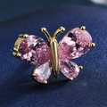 Macro detail of a butterfly brooch featuring pink teardrop crystals and gold-plated metal - 16-Pink Rhinestone Butterfly