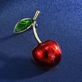 Detailed macro shot of a cherry brooch featuring red glossy fruit and green leaves - 11-One Red Cherry