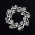Close-up of circular flower brooch with pear-cut crystals on black reflective base - Silver Pave Rhinestone Style (8)