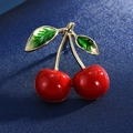 Macro shot of high-end cherry brooch with red glossy berries and green enamel leaves - 9-Two Red Cherries