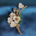 Elegant gold flower brooch with white petals, pearls and crystals on blue velvet - Ivory