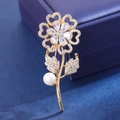Elegant sunflower brooch with sparkling cubic zirconia and pearl on jewelry box - Ivory