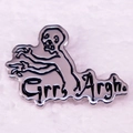 Macro shot of silver enamel zombie pin with artistic Grrr Argh text on white fabric - Floating Ghost