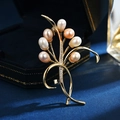 Elegant gold orchid brooch with white pink and champagne pearls on velvet background - Lemon Yellow