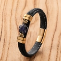Detailed view of woven black leather bracelet with golden flower clasp and blue stone - Gold-F