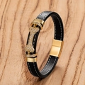 Macro view of black leather bracelet featuring a gold bone charm with sparkling crystals - Bone Style (Style-F)