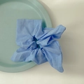 Light blue cotton fabric scrunchie with soft texture on a mint green tray - Lavender