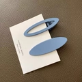 Close-up of matte Morandi blue oval hair clips on display card with handmade details - Solid And Hollow Combination / Light Grey Blue