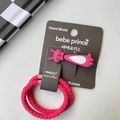 Detail of pink bunny hair clip and two bright pink elastic hair ties on display card - Rose Red Rabbit