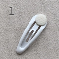 White teardrop-shaped metal BB clip with a beige round diamond-patterned decorative button - White
