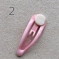 Pink teardrop metal snap hair clip with a white textured circular accent detail - Light Pink
