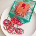 Detailed close-up of colorful striped elastic hair bands in transparent bear packaging - Dual Bright Color Style (15) / Splice Style