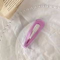 Close-up of a translucent light purple jelly hair clip on a decorative glass tray - Water Drop Shape / Transparent Purple