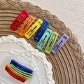 Detailed view of matte rainbow hair clips in seven colors with a clear storage box - Rectangle