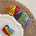 Macro detail of colorful matte triangle BB hair clips with hollow design in storage box - Triangle