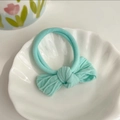 Mint green elastic hair tie with bow ornament on a white shell plate for girls - Mint Green