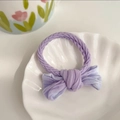 Soft purple bow hair tie with knitted texture on a decorative white shell tray - Gradient Purple