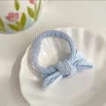 Light blue braided elastic hair tie with a matching soft bow in a white shell dish - Gradient Blue