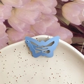 Sweet Y2K light blue matte butterfly hair clip placed on a ceramic dish with tulips - Butterfly Shape / Blue