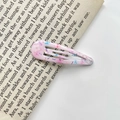 Pink teardrop BB hair clip with colorful floral ink pattern on an English book page - 36# Subtle Flower