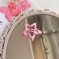 Fermaglio a stella rosa con pois colorati su sfondo decorativo di specchio vintage - Rosa