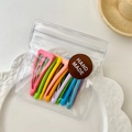 Set of ten colorful candy-colored snap hair clips in a transparent zip bag - Triangle