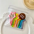 Set of 10 candy-colored star-shaped hair clips in handmade packaging on white plate - Pentagram
