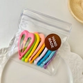 Assorted candy-colored heart-shaped hair clips in clear packaging with handmade sticker - Heart