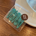 Five pieces of candy-colored teal drip glue snap hair clips in a gift bag - Emerald