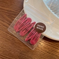 Set of 4 matte pink waterdrop BB hair clips in handmade packaging on a rustic table - Charming Purple Rose