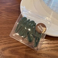 Five dark green matte water drop hair clips in a handmade packaging bag on a desk - Dark Green