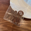 Set of 4 brown macaron-colored teardrop metal BB hair clips on wooden surface - Coffee
