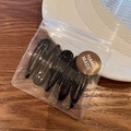 Set of 5 black metal teardrop hair clips in a handmade packaging bag on wooden desk - Black