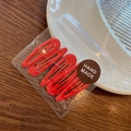 Set of four red water-drop BB hair clips in handmade packaging on a white plate - Red