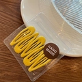 Five yellow macaron-colored teardrop BB hair clips in handmade packaging on wooden table - Bright Yellow