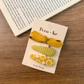 Set di 3 fermagli per capelli in tessuto giallo con fiocchi e motivi floreali per bimbe - Giallo