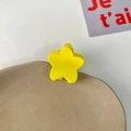 Matte yellow star-shaped mini hair claw clip for girls displayed on a beige tray - Yellow Pentagram